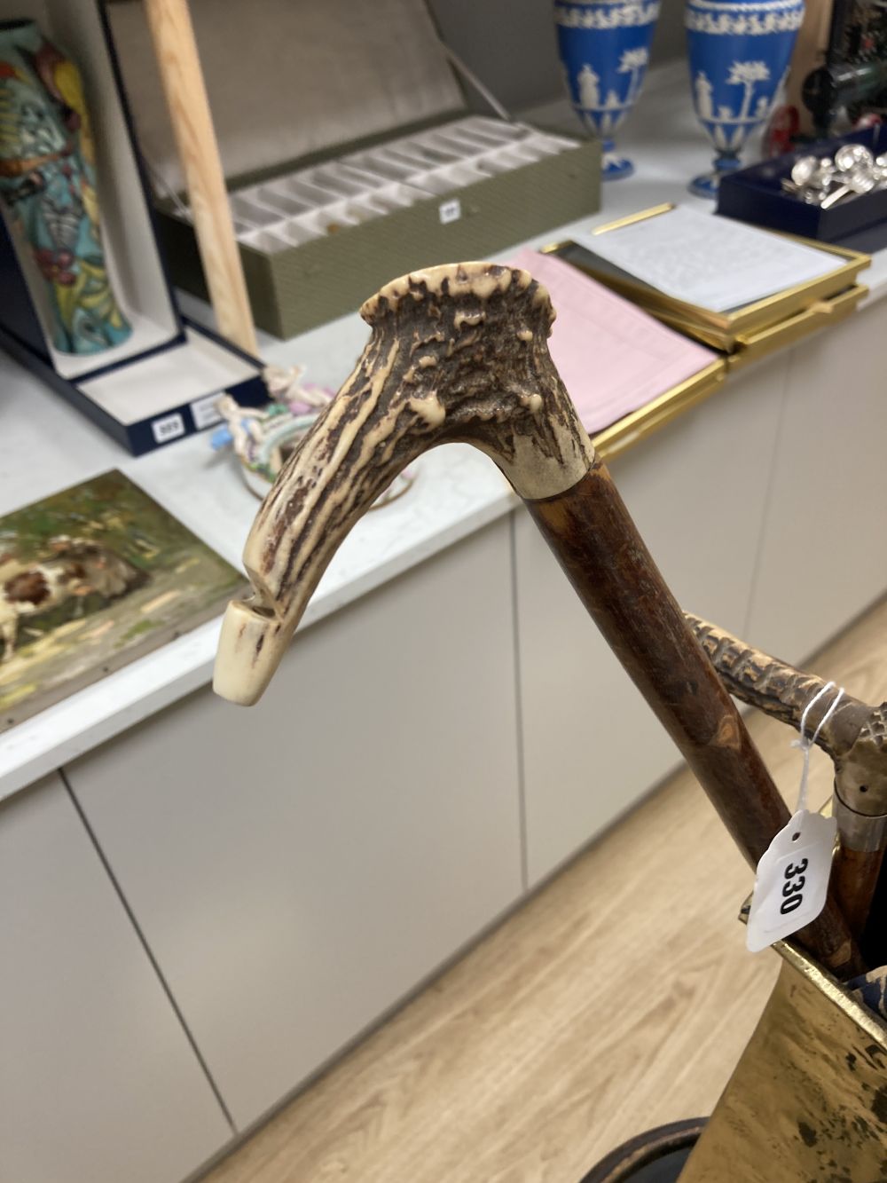 A carved tripod vase stand, an Arts & Crafts hammered brass vase, height 56cm, two umbrellas and two walking sticks